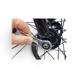 15mm ratchet wrench being used on a bicycle wheel axle nut