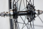Close-up of XFIXXI 700C flip-flop rear hub with 16T fixed cog and sealed bearings.