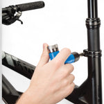 Cyclist using Park Tool ATD-1.2 Adjustable Torque Driver to tighten bike stem bolt