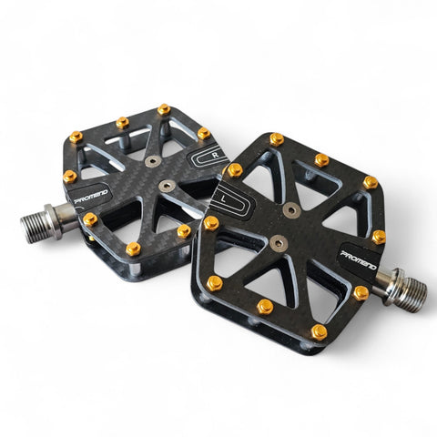 Dual-sided carbon fiber bike pedals with titanium spindle and gold removable spikes