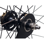 Fixed cog lockring tool in use on rear wheel hub of track bike.