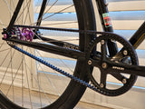 Close-up of XFIXXI TrackloX Gates CDX Carbon Belt Drive, featuring a black crankset, 50T/60T chainring, and a 115T carbon belt